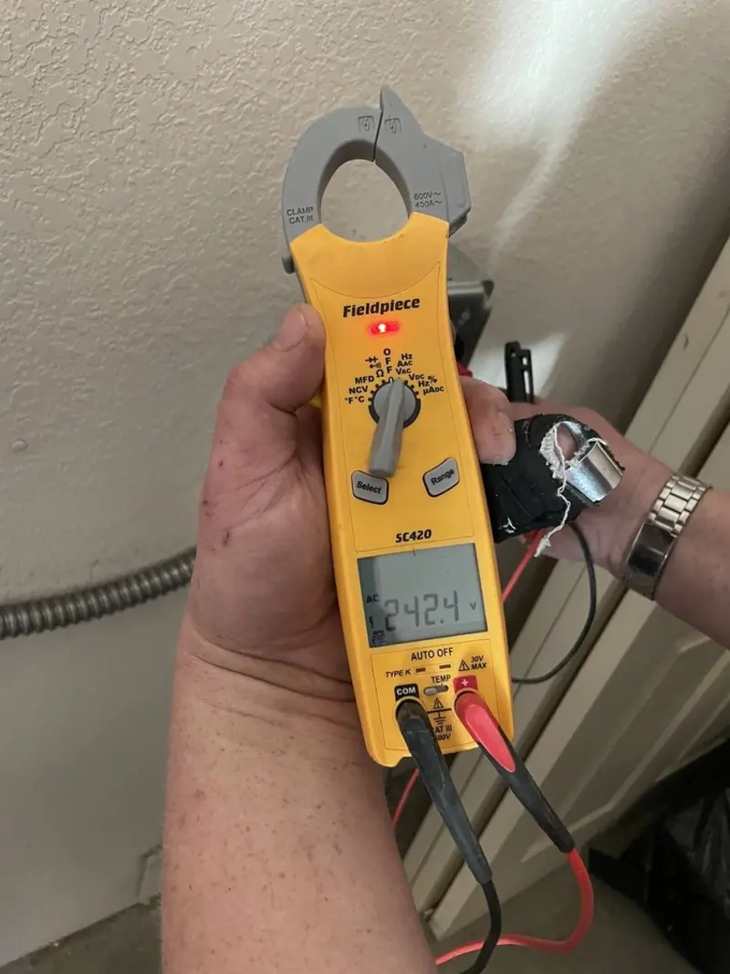 Voltage testing with clamp meter during Outlet Installation in Bostonia